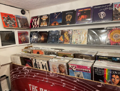 Wall of classic rock album covers on display above the record bins.