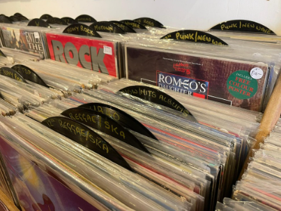 Top-down view into a record crate with hand-lettered genre tabs.