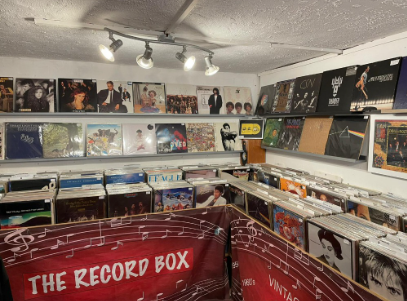 The Record Box interior — red banner across the wall with record bins and album display behind.